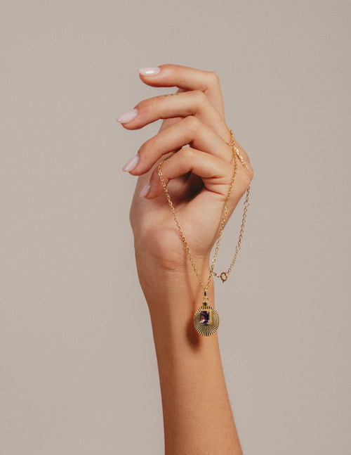 VERAE amethyst and peridot necklace held by hand
