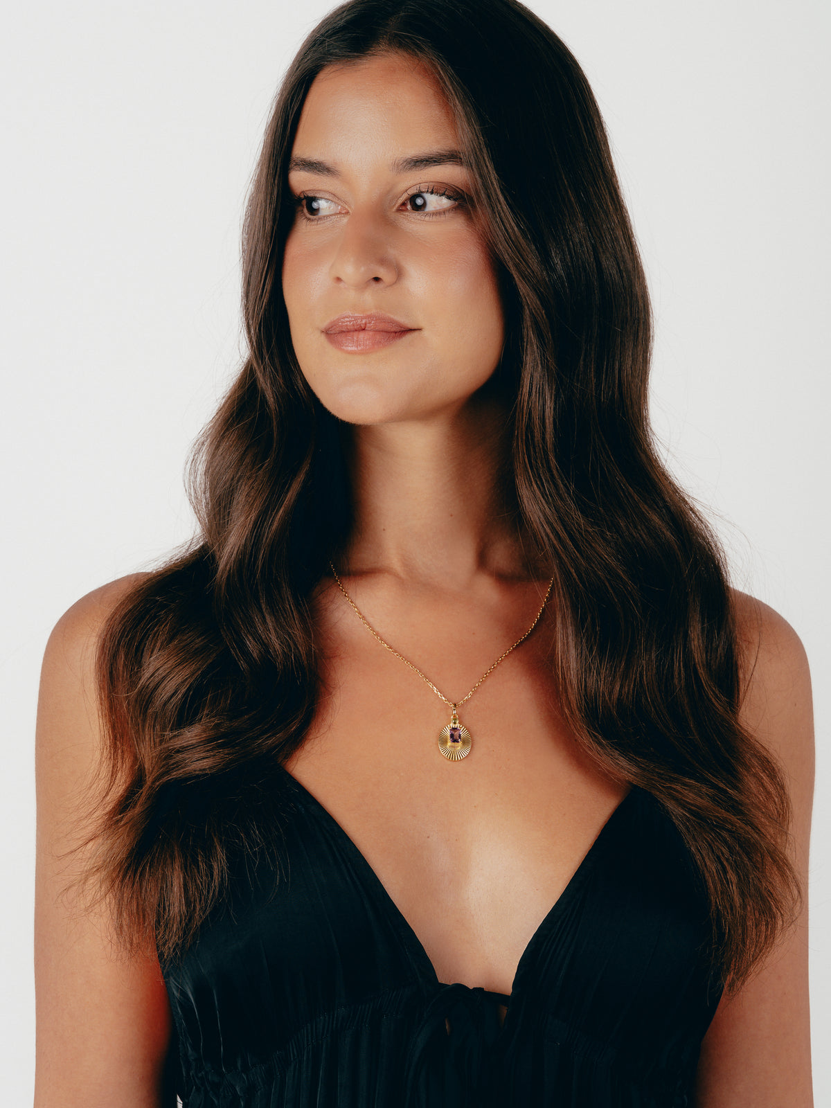 Model wearing VERAE amethyst and peridot pendant necklace
