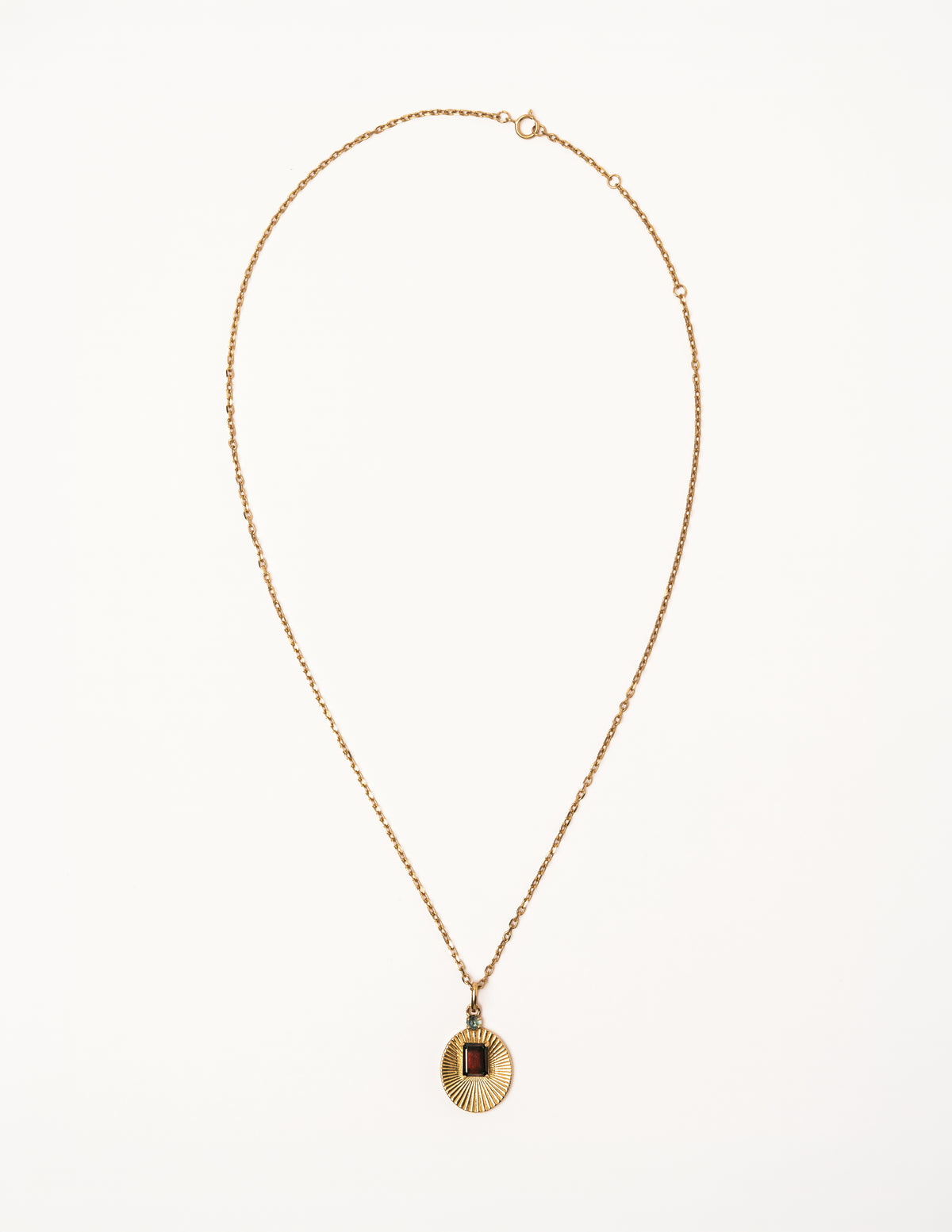 Full view of VERAE garnet and blue topaz pendant necklace