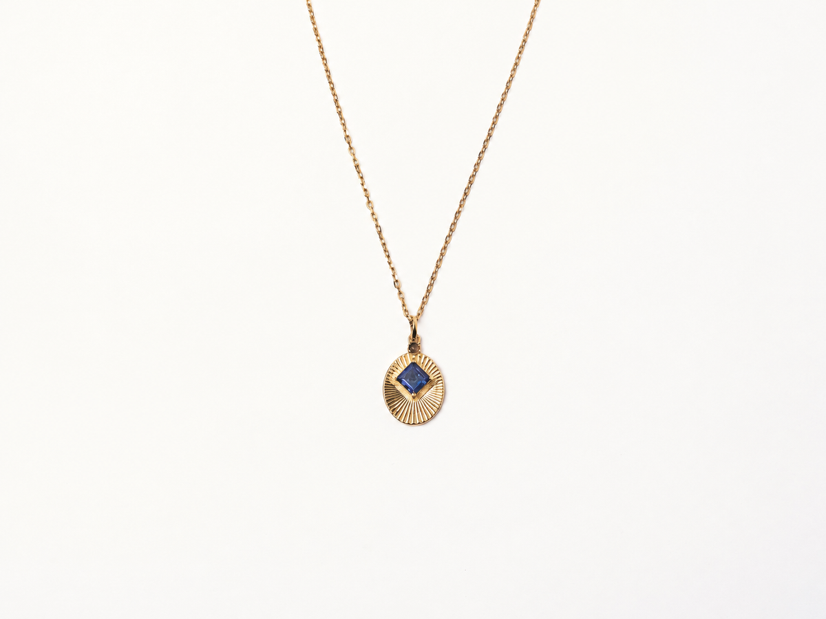 VERAE RETURN gold necklace featuring an iolite gemstone pendant