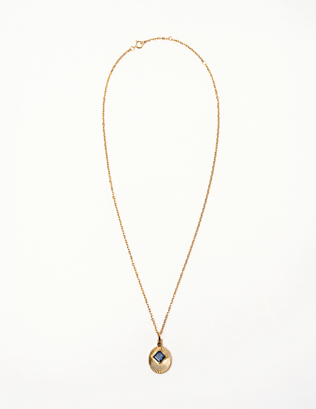 VERAE RETURN gold necklace featuring an iolite gemstone pendant