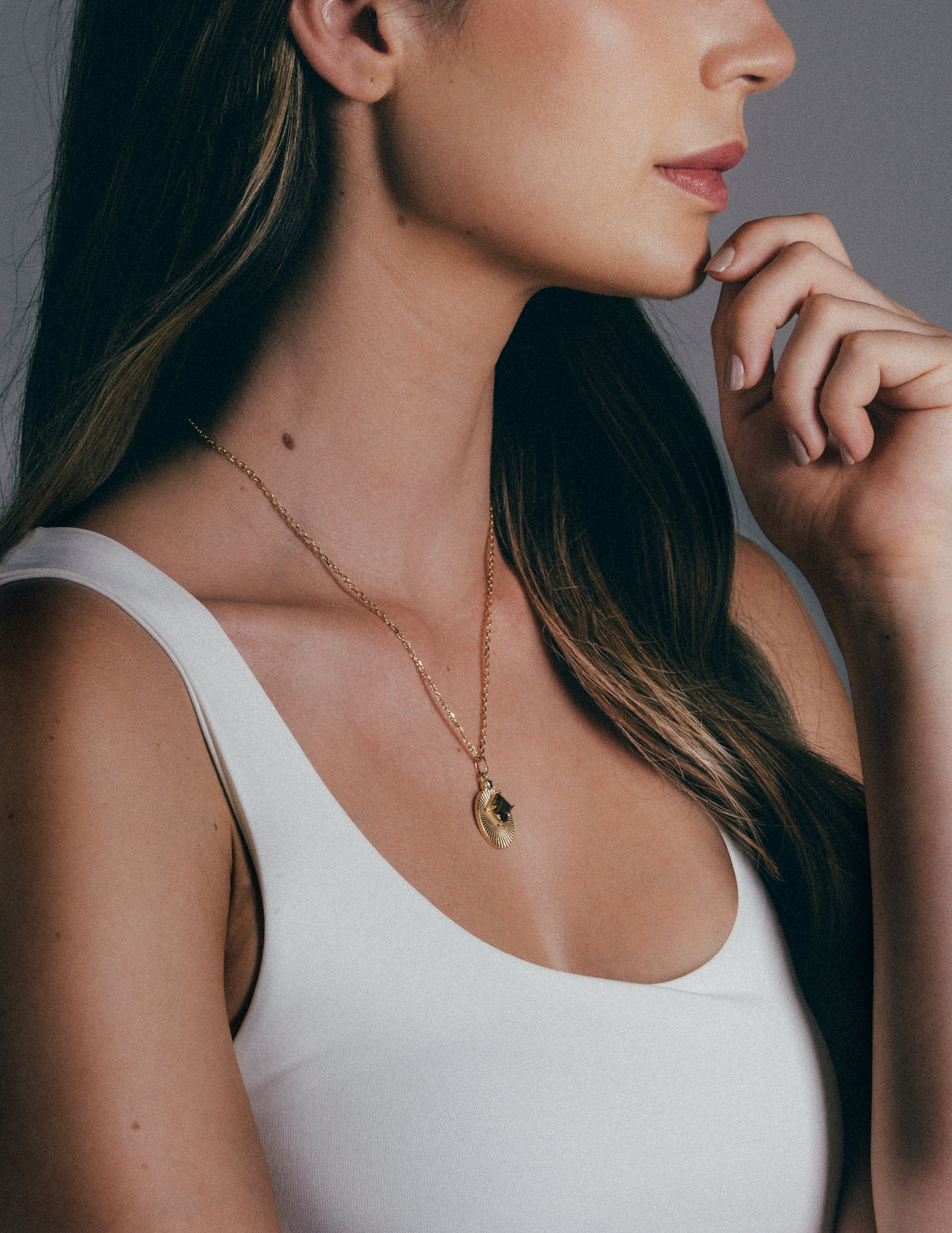 Model wearing a VERAE natural stone pendant necklace