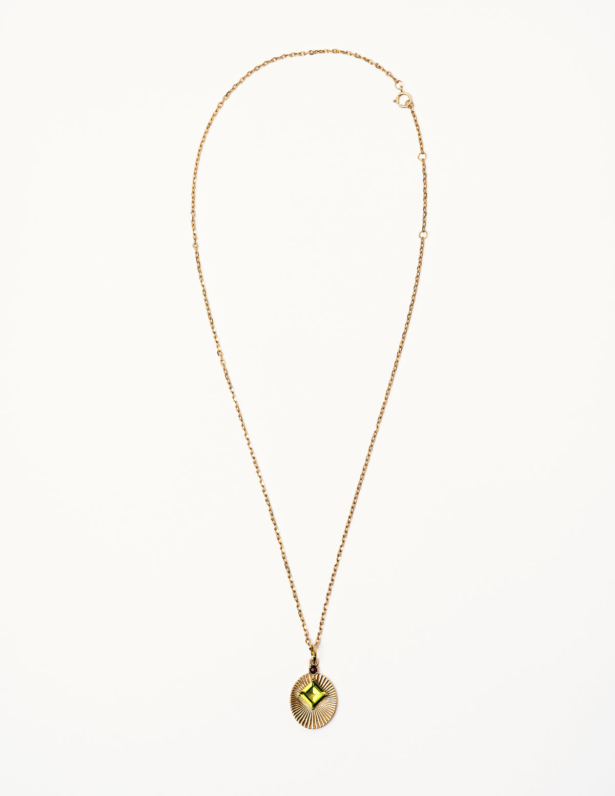 Full view of VERAE peridot and garnet pendant necklace