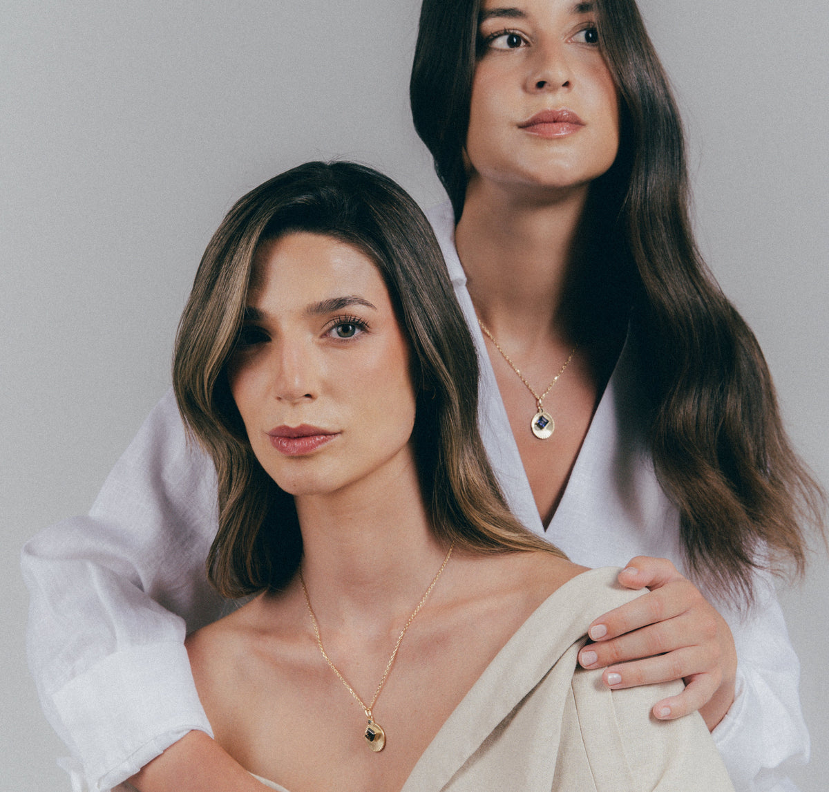 Models wearing natural stone necklaces from the VERAE RETURN collection